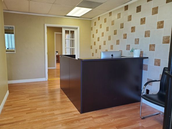 TILE AND WOOD FLOOR RECEPTION AREA. 5 OFFICES AND LARGE ROOM